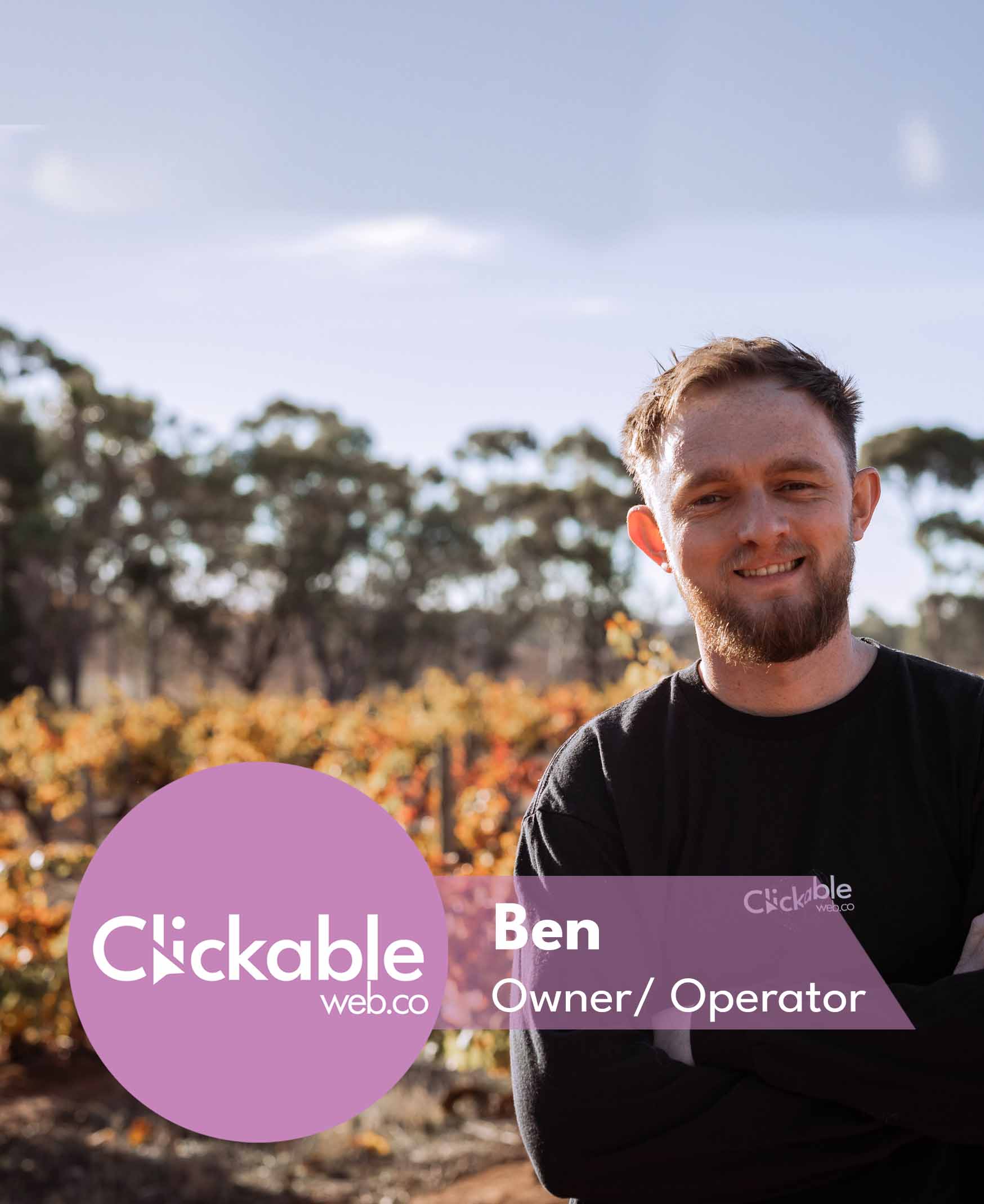 Founder of Clickable Web Co standing in a Barossa Valley vineyard wearing a Clickable Web Co jumper