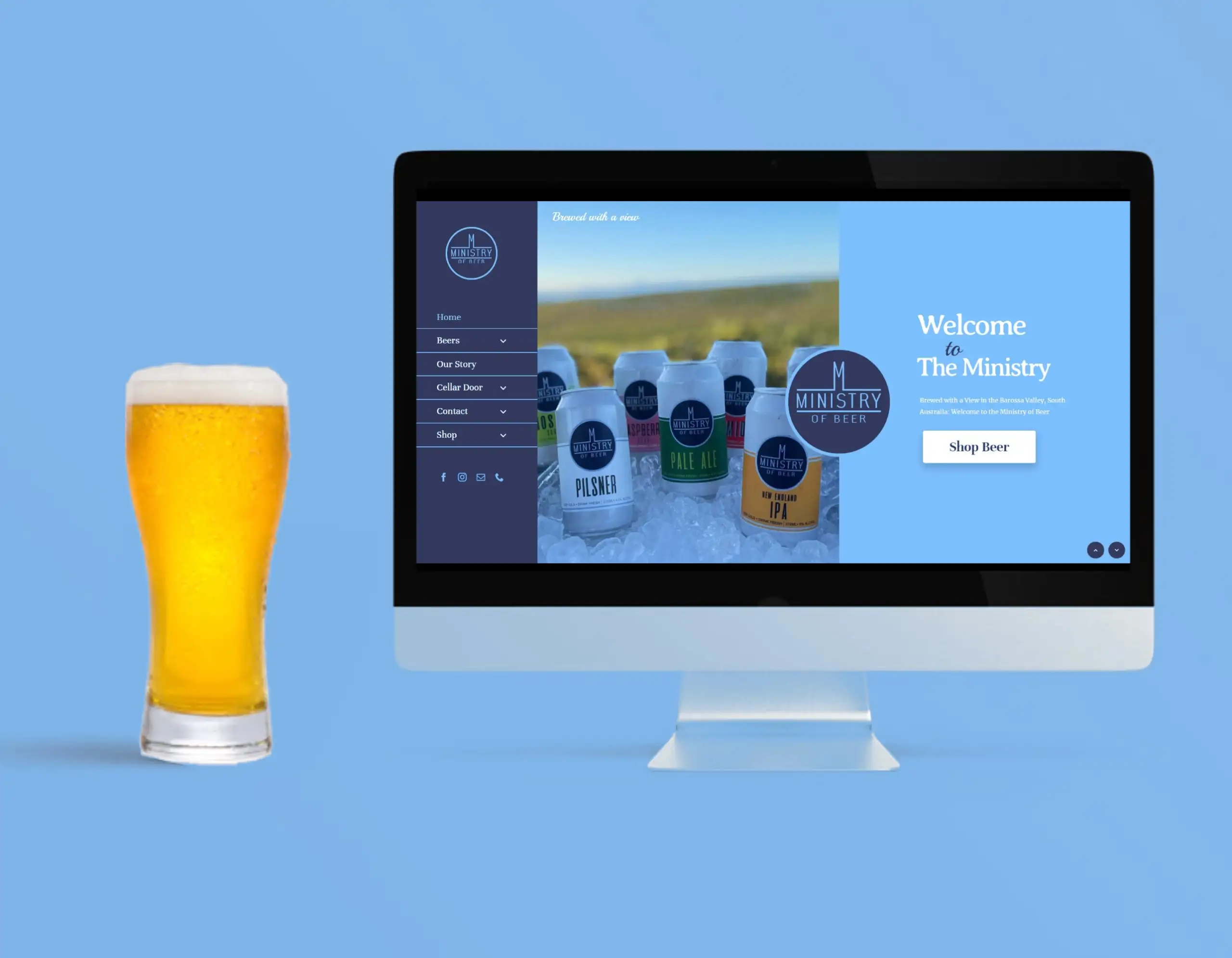 Computer screen showing the Ministry of Beer website with beer cans on ice, displayed beside a tall glass of beer on a blue background.